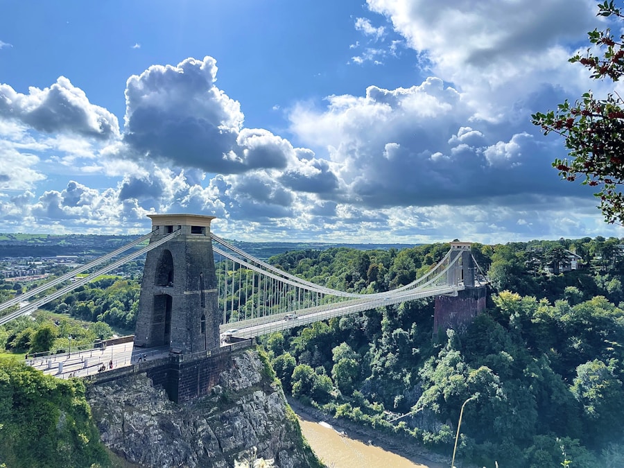 Historic suspension bridge over a river, similar in era and style to the Waco Suspension Bridge over the Brazos River
