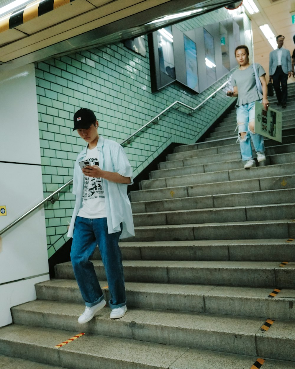 a man standing on a set of stairs using a cell phone
