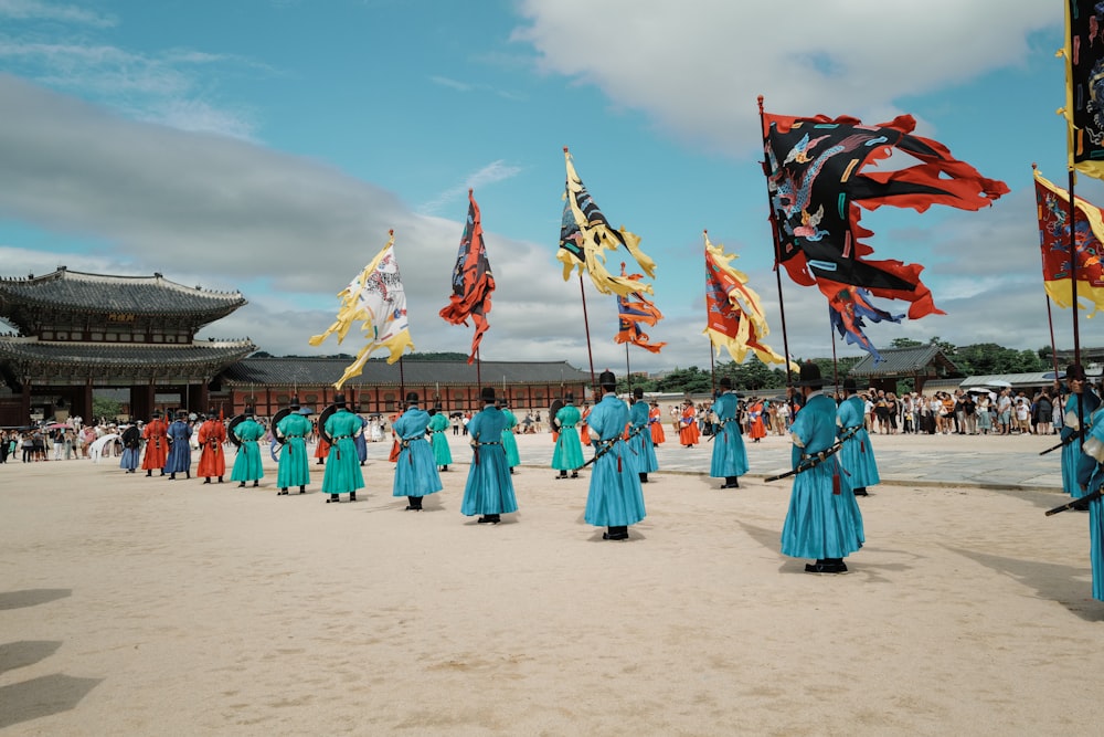 a group of people in blue dresses holding flags