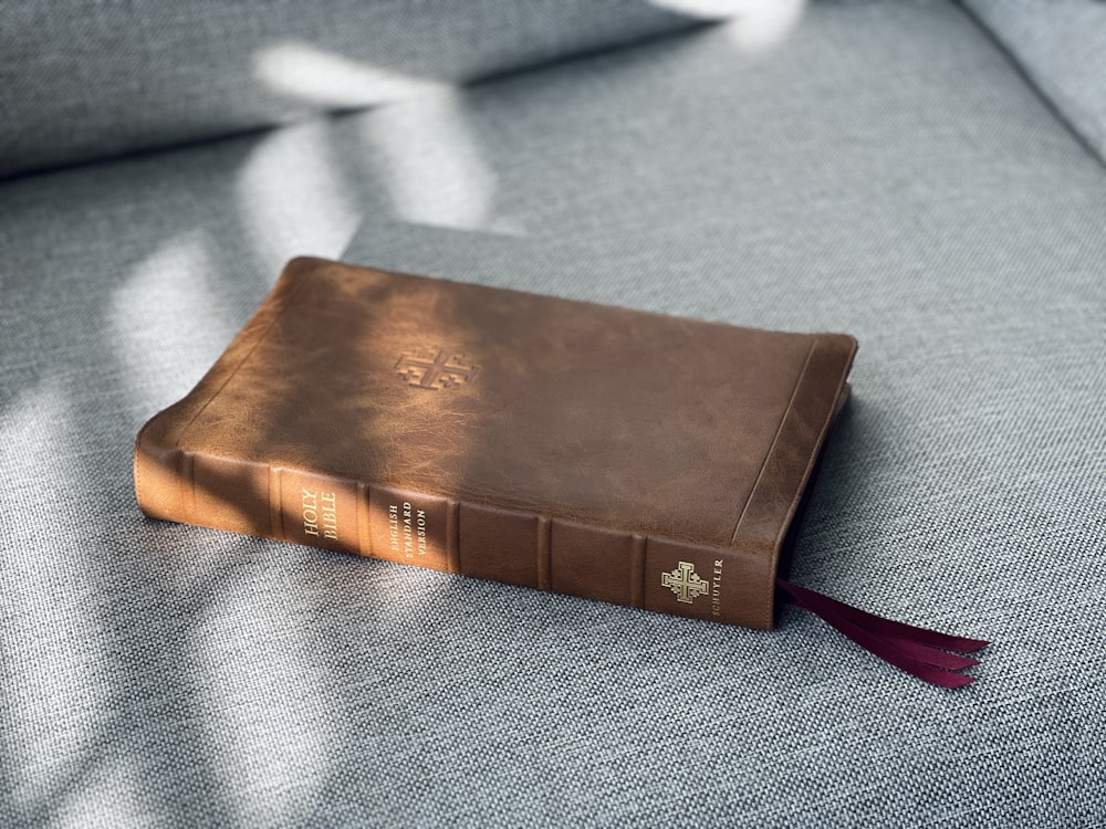 a brown book sitting on top of a gray couch