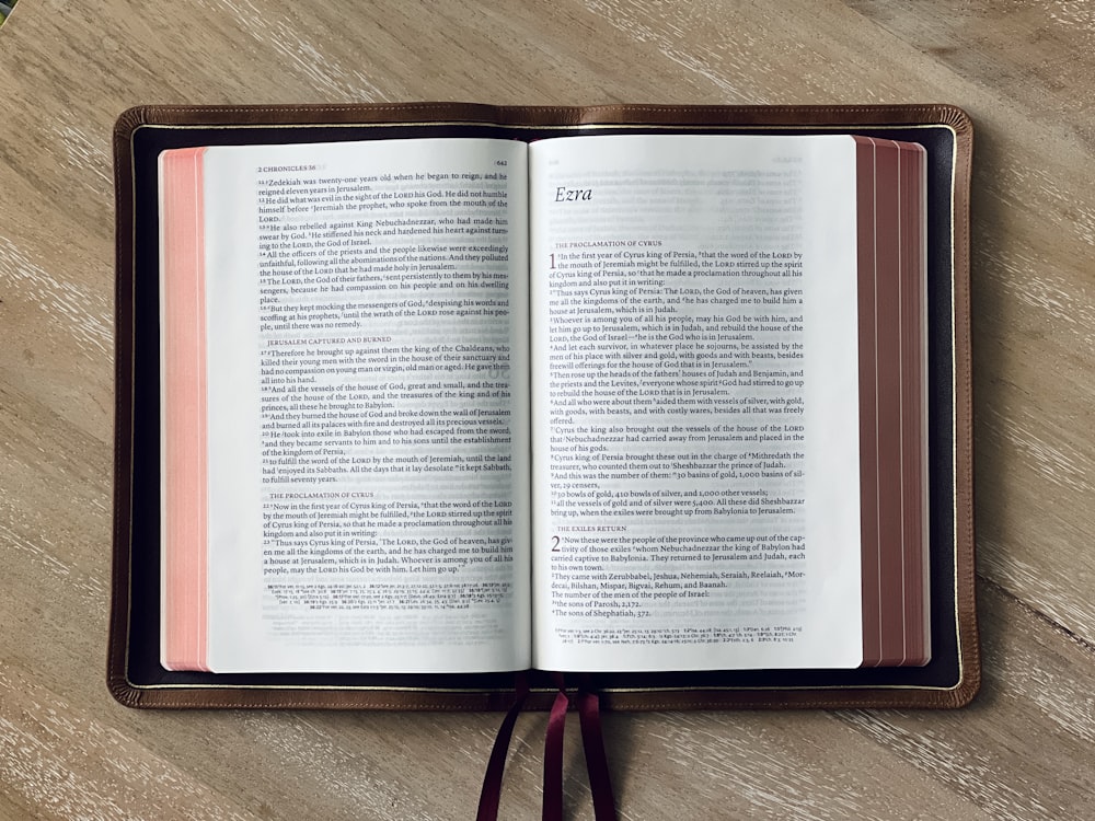 an open book sitting on top of a wooden table