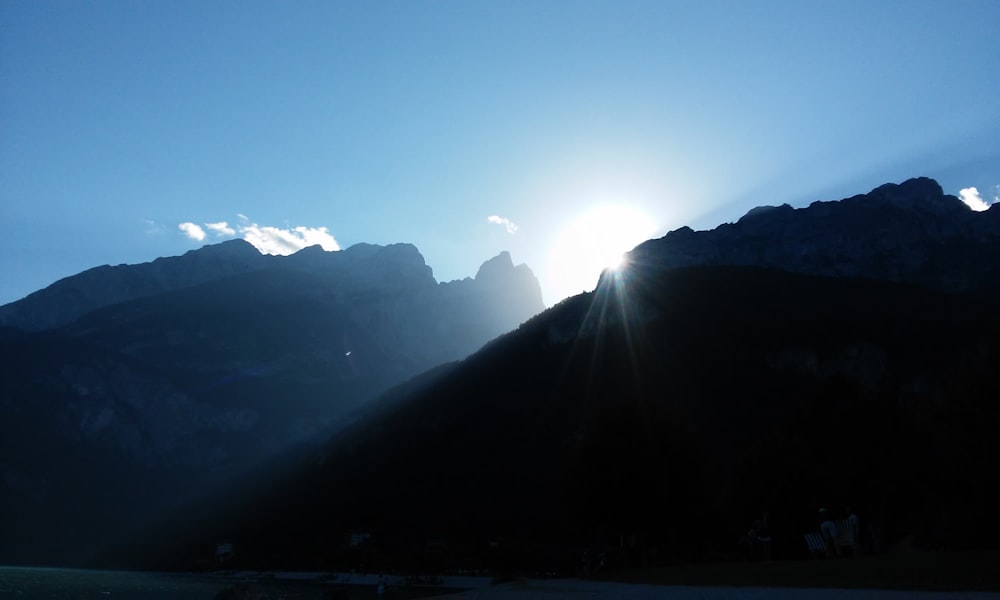 the sun shines brightly through the mountains