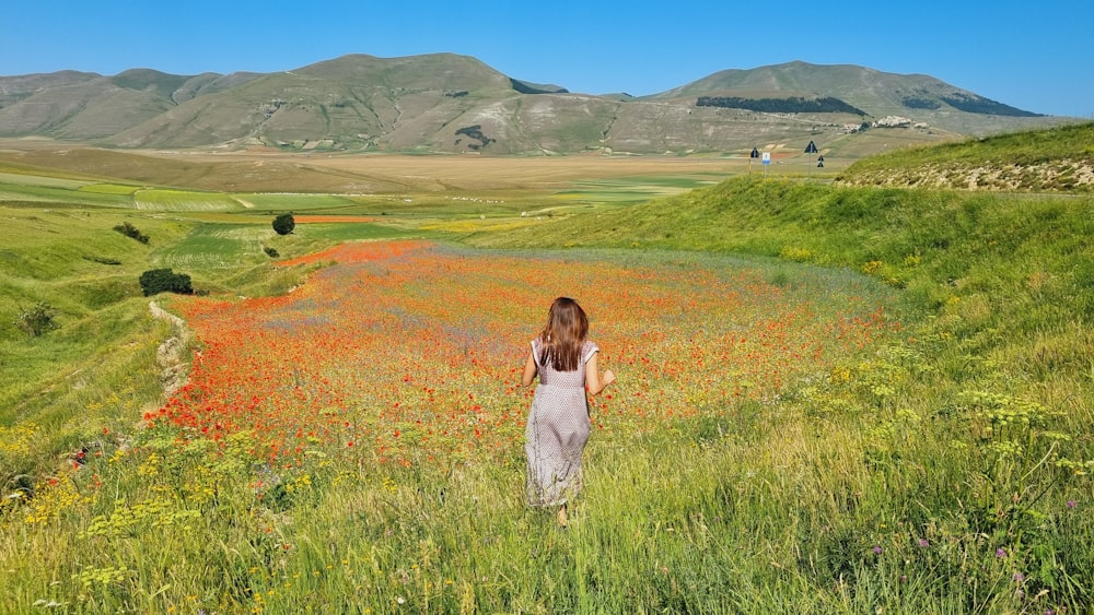 a woman standing in a field of wildflowers