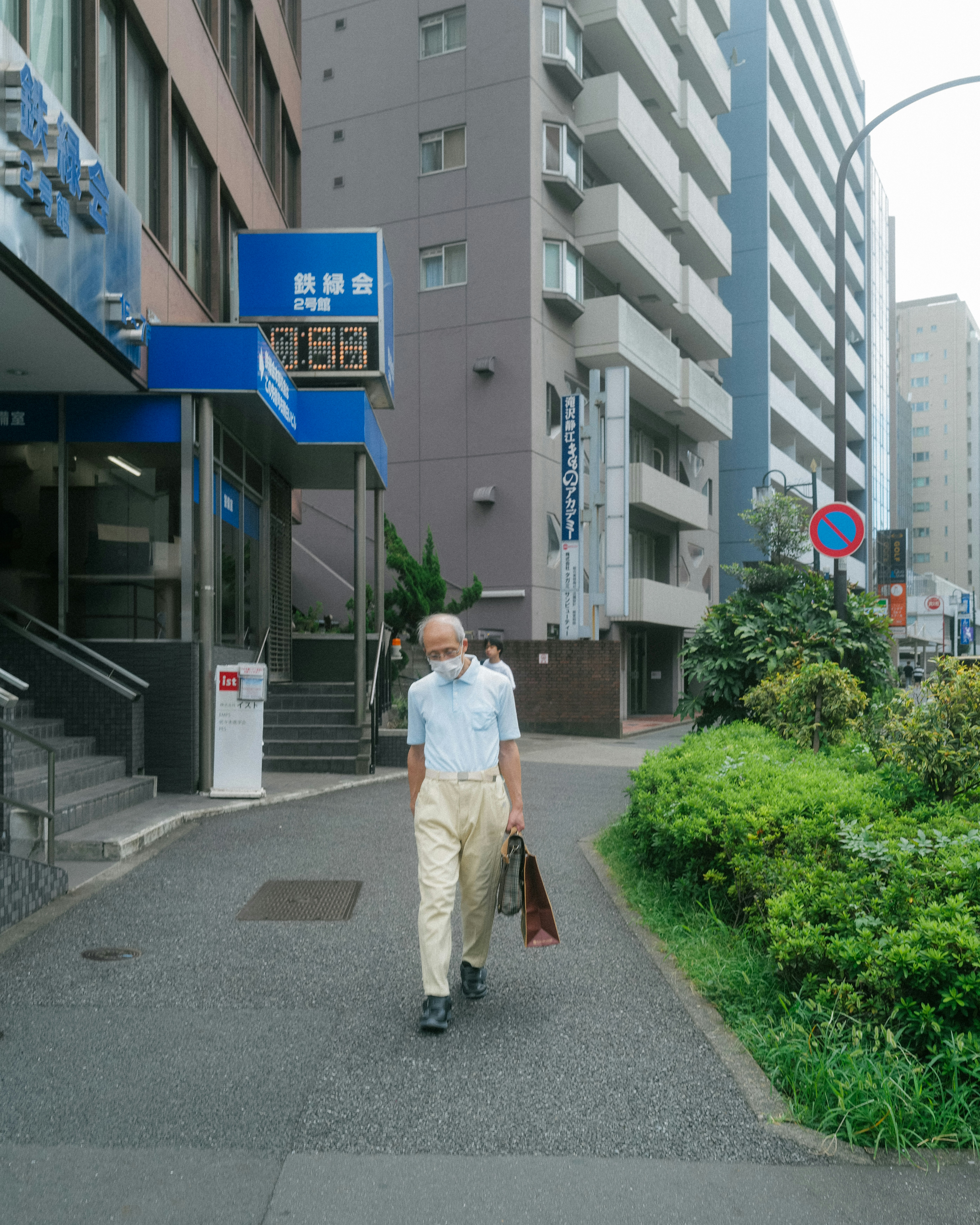 a man walking down a street carrying a suitcase