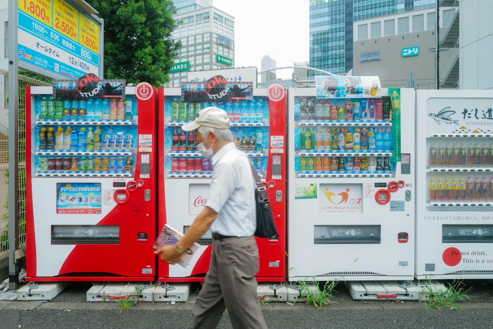 a man walking past a vending machine