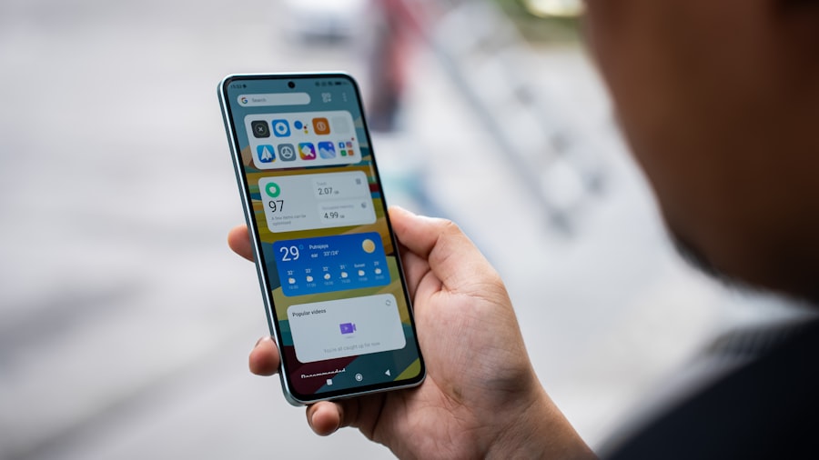 Smartphone on desk with laptop