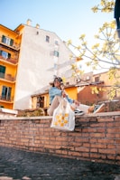 A stylish lady with a tote bag, laughing as she enjoys a sunny afternoon.