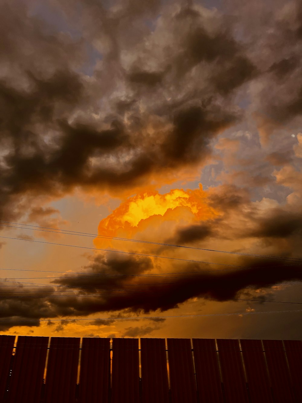 the sky is dark and cloudy with a yellow cloud