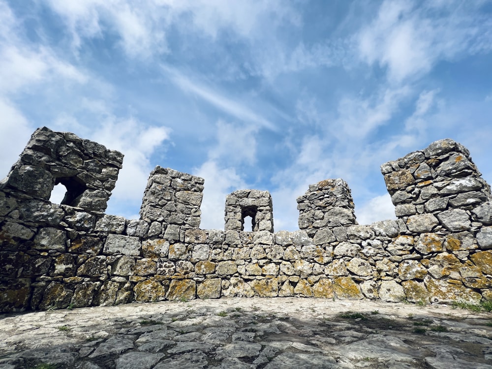 a stone wall with a sky background