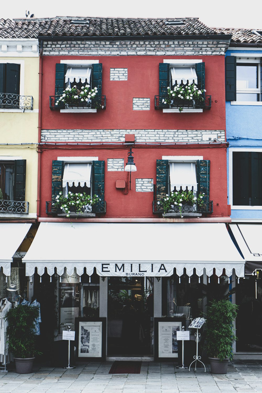 a red building with a white awning and windows