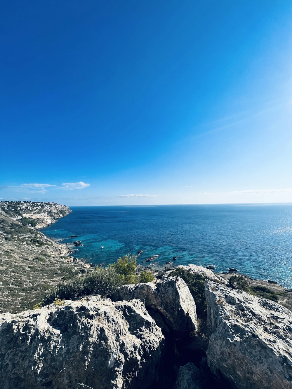 a view of the ocean from the top of a hill