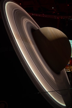 A detailed and realistic model of a planet with prominent rings, resembling Saturn, set against a dark background.