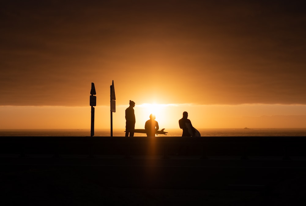 a couple of people sitting on top of a bench