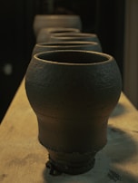 Close-up of traditional handcrafted pottery displayed on a rustic wooden table.