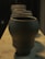 Artisan clay pots arranged artistically in a bright, natural light setting.