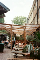 Guests enjoying a lively celebration in a charming outdoor courtyard.