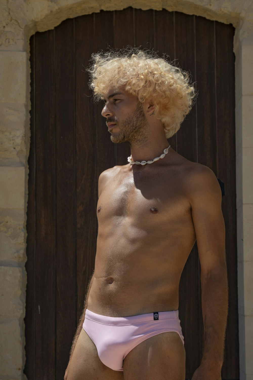 a man with blonde hair wearing a pink underwear