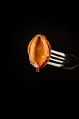 Glossy sauce dripping from a perfectly wrapped pita, set against an elegant black and gold background.