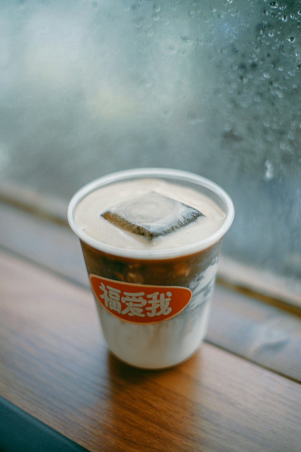a cup of coffee sitting on a window sill