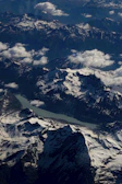 Sunrise over the snow-capped peaks of Spiti Valley with a winding river below.