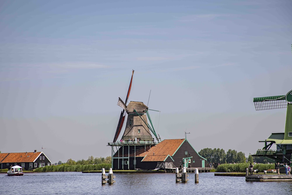 a group of windmills sitting on top of a body of water