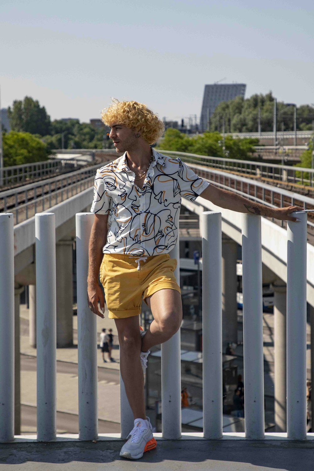 a man in yellow shorts and a white shirt