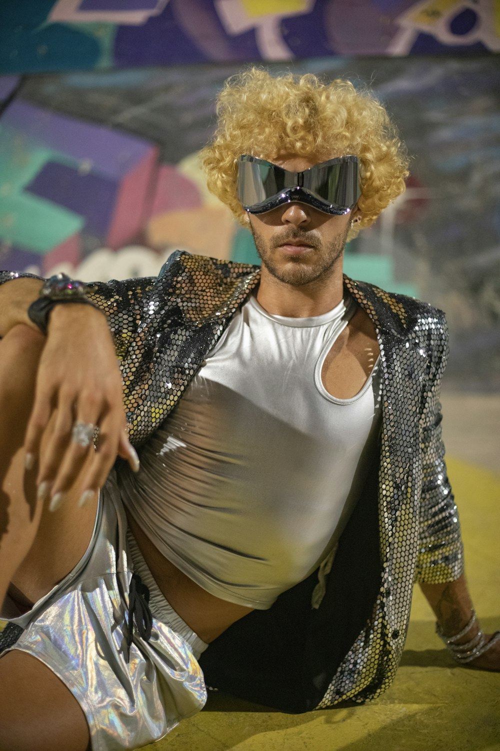 a man wearing a silver outfit and a pair of sunglasses