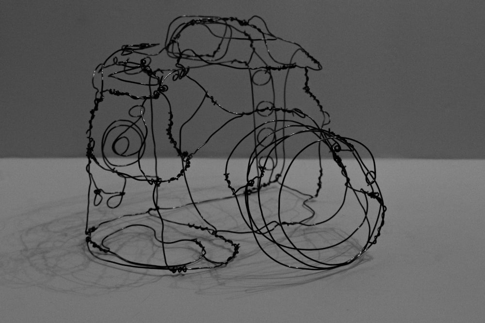 a wire sculpture sitting on top of a table