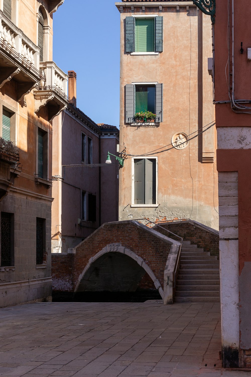 a bridge over a small canal in a city