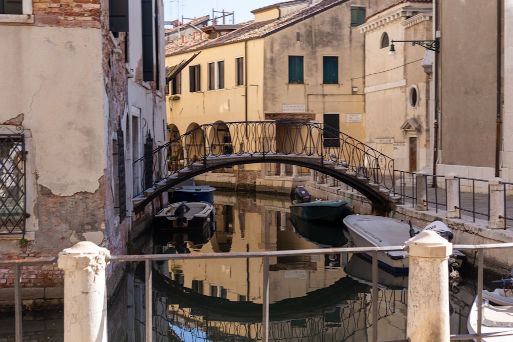 a bridge over a small canal in a city