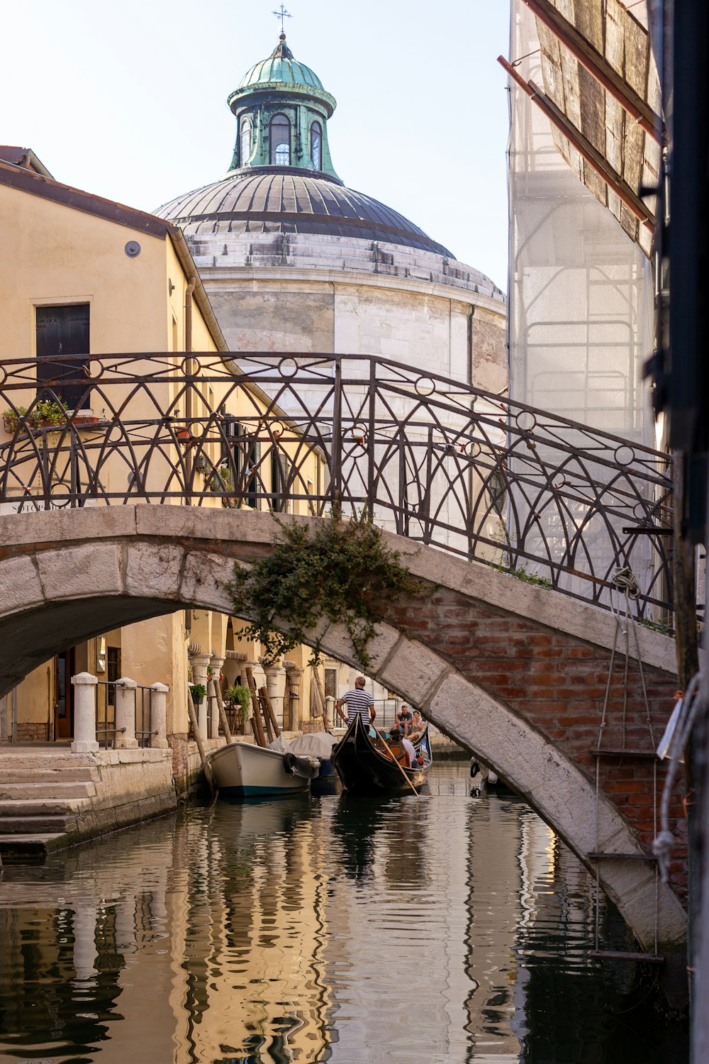 a bridge over a body of water next to a building