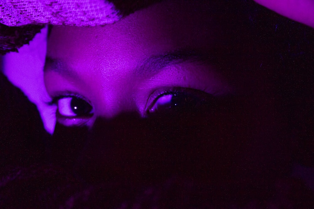 a close up of a person's face in the dark