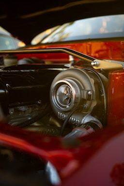 Close-up of a technician carefully inspecting a turbocharger in a modern workshop.
