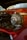 A close-up view of a car engine with prominent focus on a turbocharger. The engine components showcase a mixture of metallic and glossy surfaces, reflecting the surrounding light. The background is slightly blurred, highlighting the details of the engine.