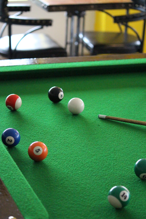 a pool table with several pool balls on it