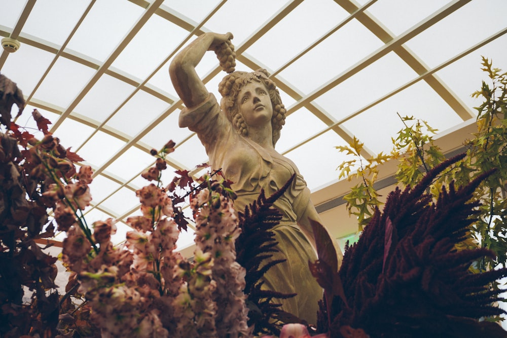a statue of a woman is surrounded by flowers
