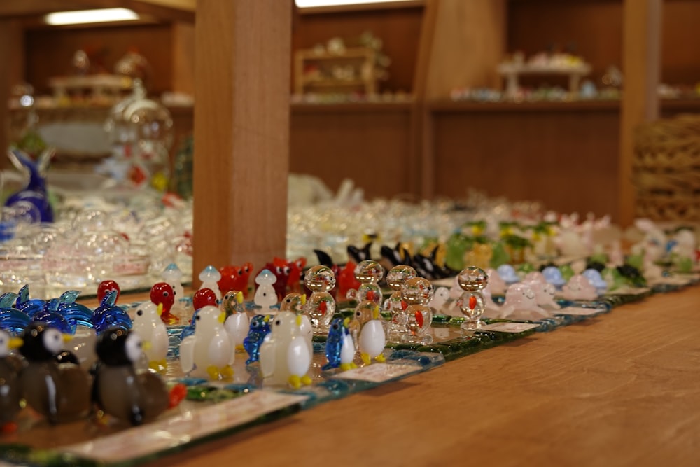 a collection of glass figurines sitting on top of a wooden table