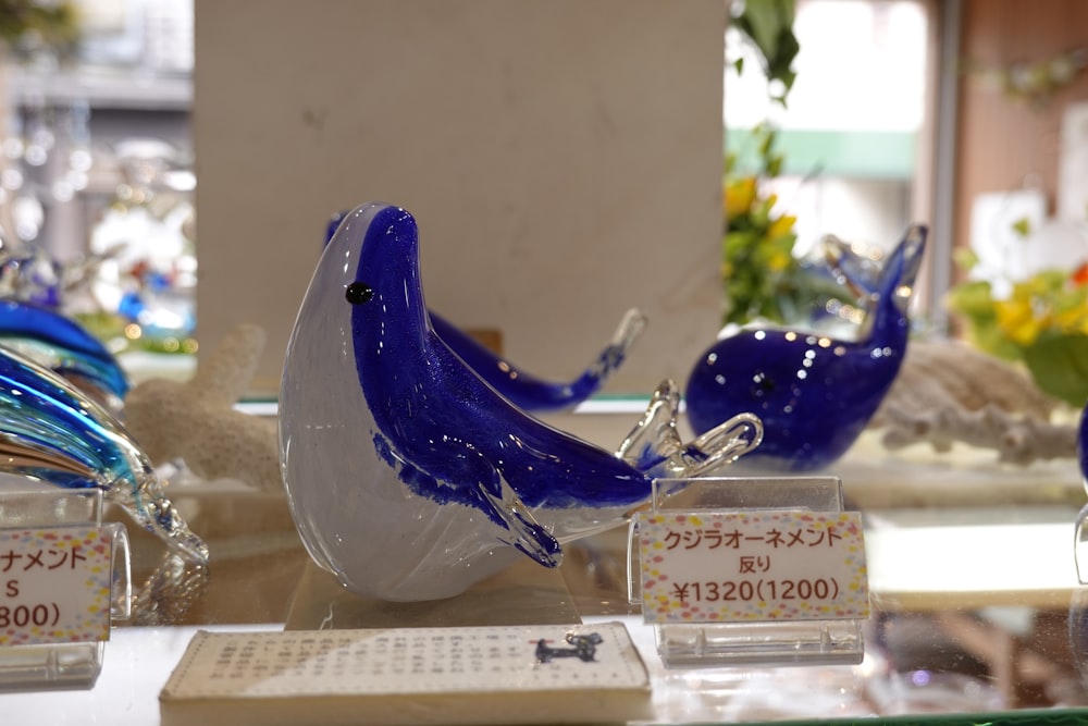 a blue bird figurine sitting on top of a table