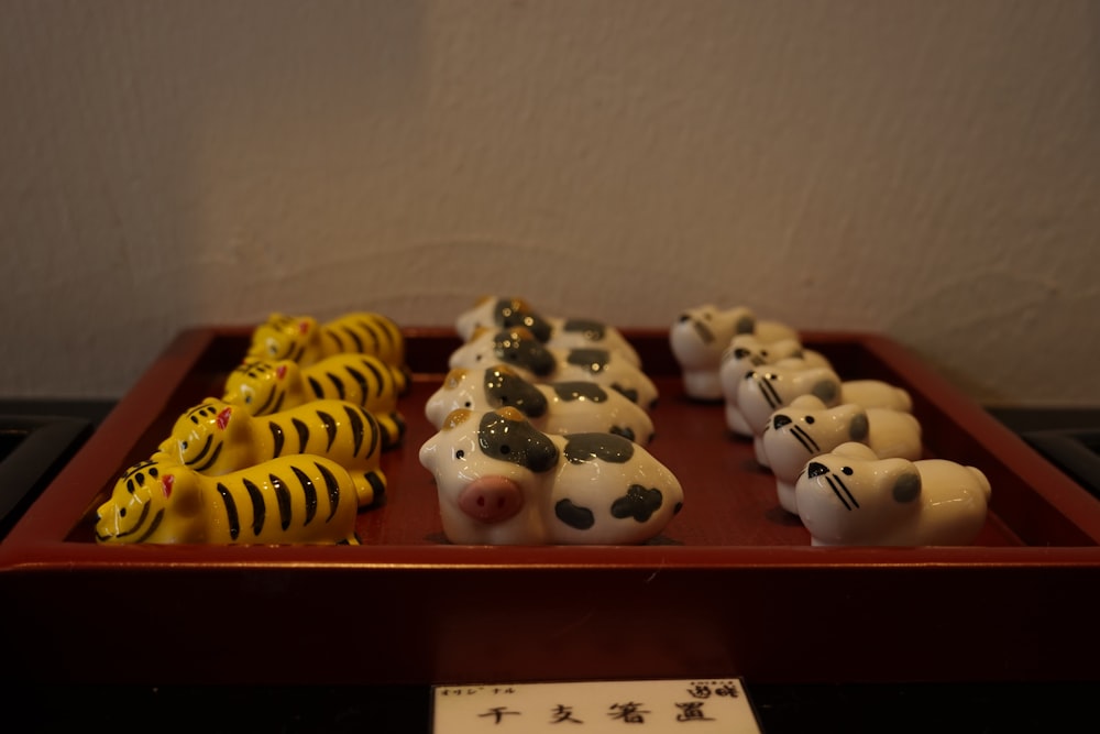 a red tray topped with different types of toy animals