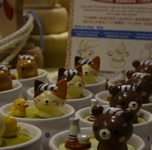 a table topped with cups filled with small toy animals