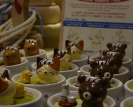 a table topped with cups filled with small toy animals