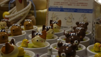 a table topped with cups filled with small toy animals