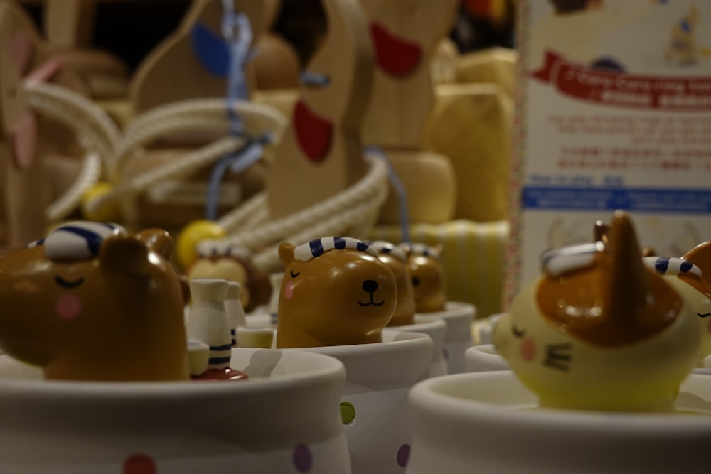 a close up of small ceramic animals in cups