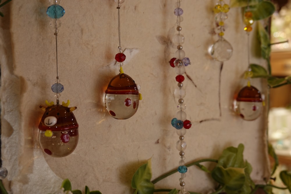 a group of glass ornaments hanging from a wall