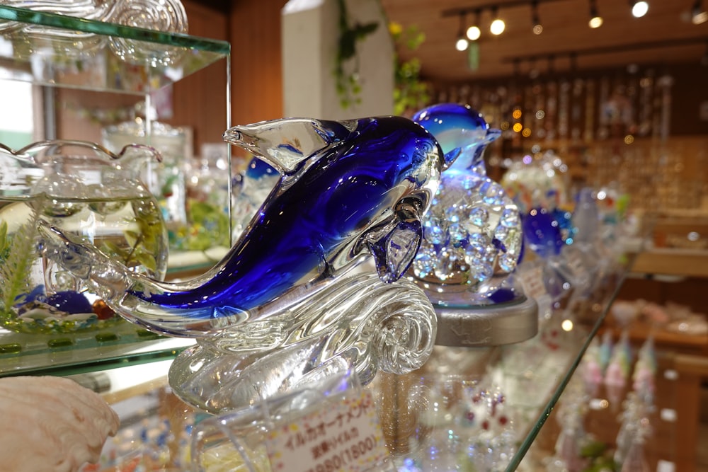 a glass figurine of a horse on a glass shelf