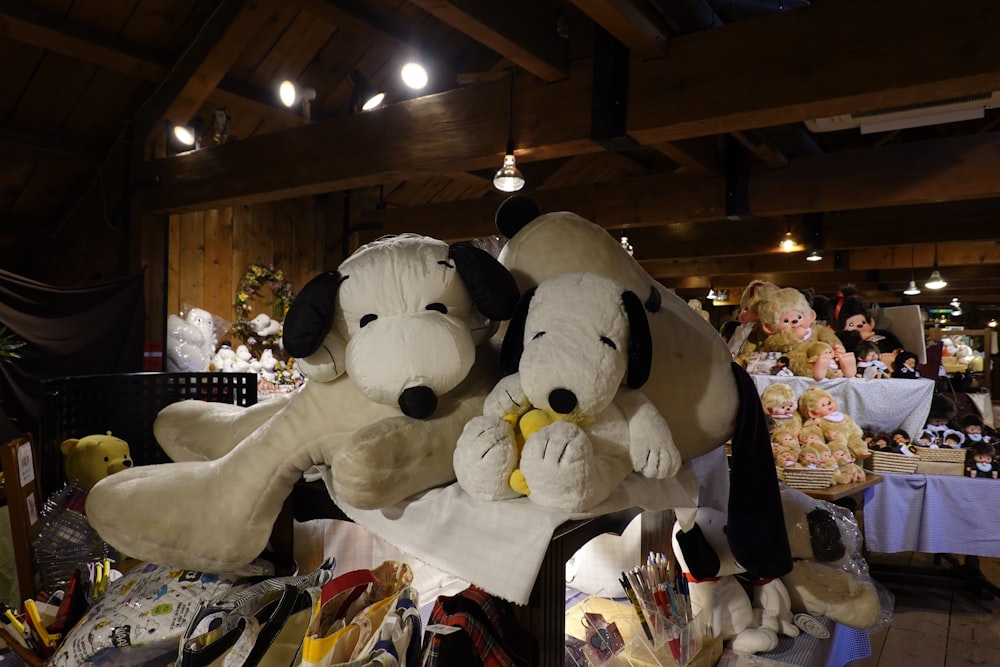 two stuffed dogs sitting on top of a table