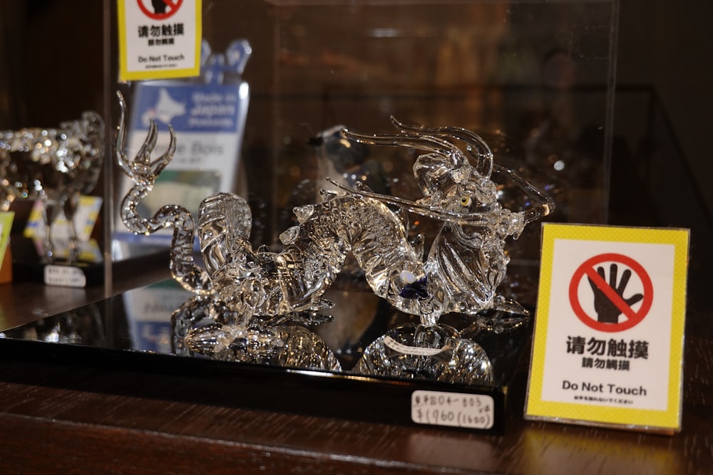 a group of glass figurines sitting on top of a wooden table