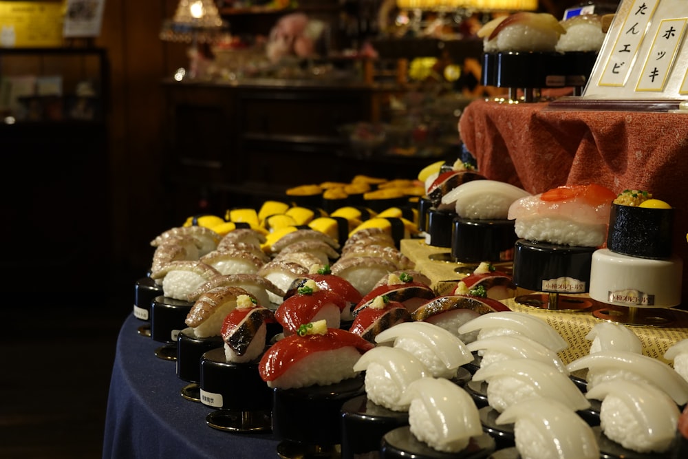 a table topped with lots of different types of sushi