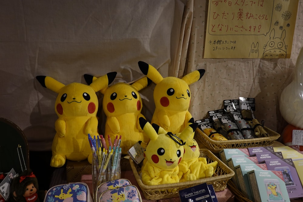 a group of stuffed pikachu sitting on top of a table