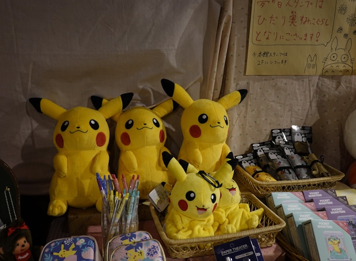 a group of stuffed pikachu sitting on top of a table